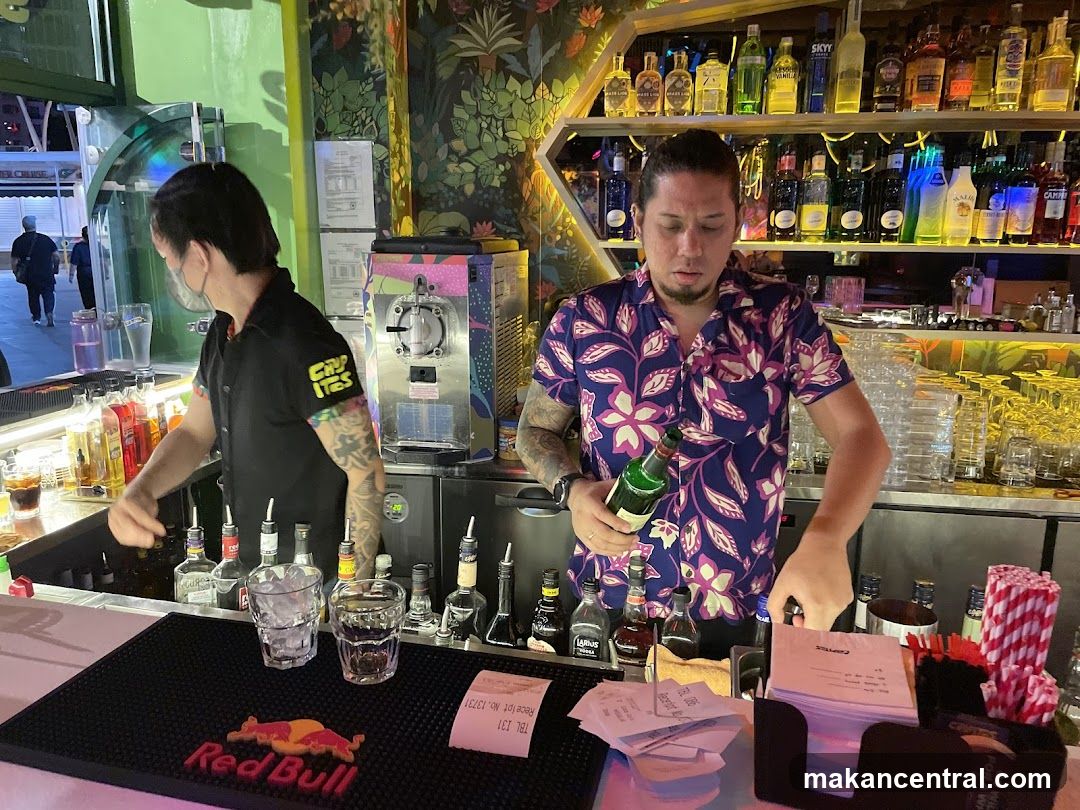 Bartenders preparing drinks at a bar