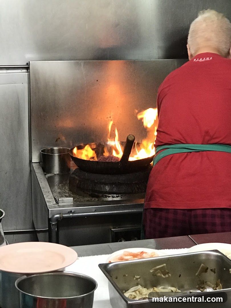 Chef cooking with a wok