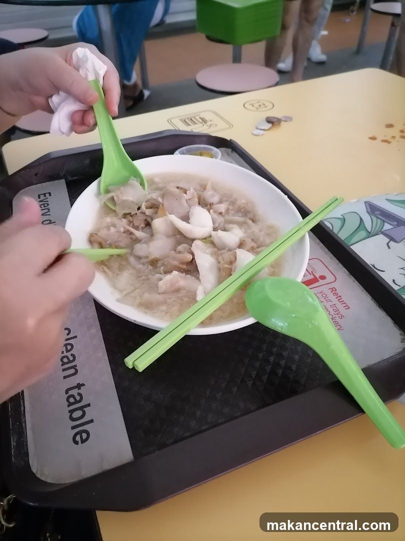 Bowl of food with chopsticks and spoon