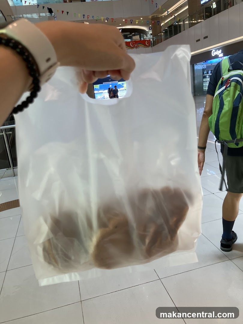 Person holding a plastic bag with food
