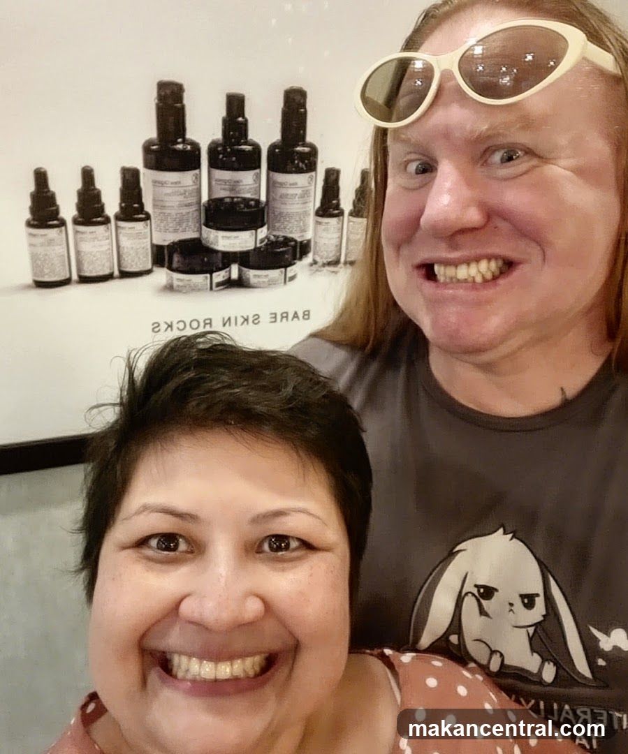 Two people posing in front of a display of skincare products