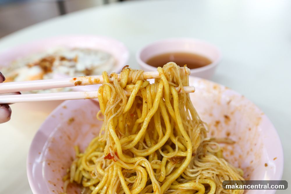 Noodles being lifted with chopsticks