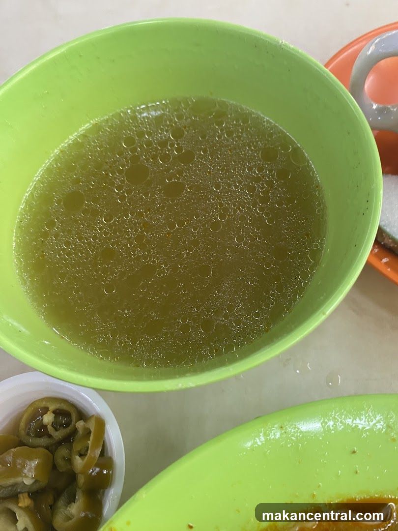 Bowl of Broth with Sliced Chilies
