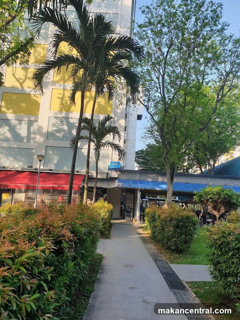 Outdoor walkway with shops and greenery