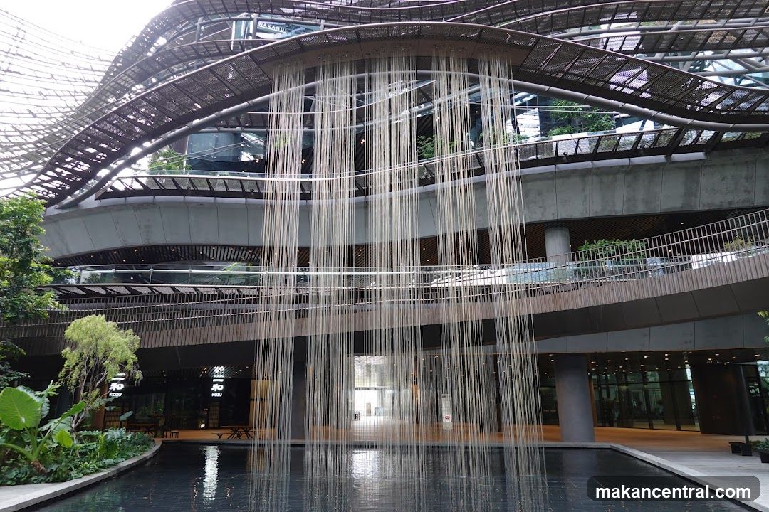 Modern Building with Hanging Vines and Water Feature