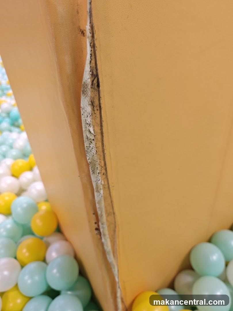 Close-up of a damaged orange structure in a ball pit