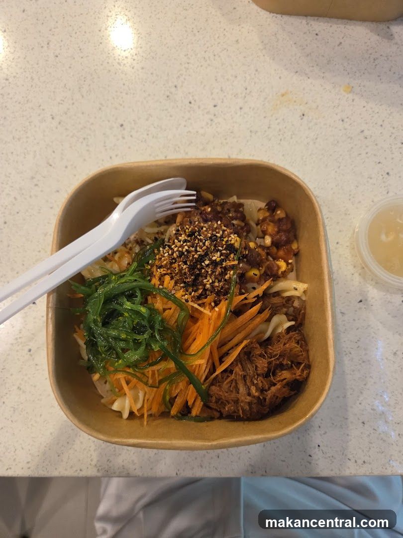 Bowl of food with shredded meat and vegetables