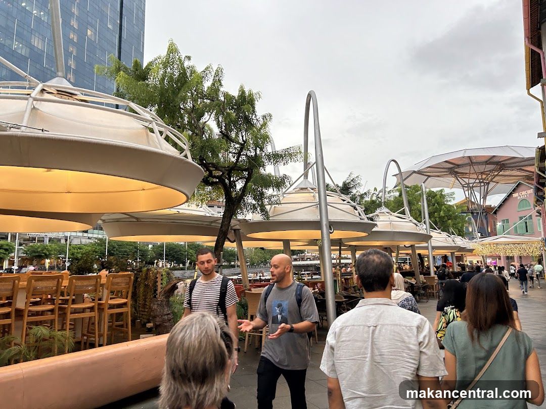 Outdoor dining area with people walking