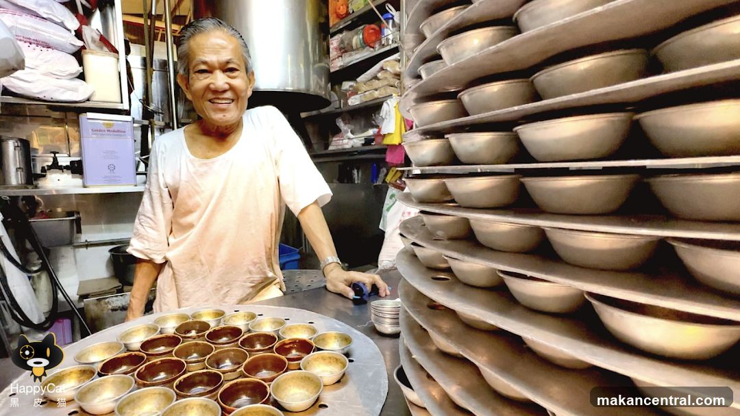 Man in a Kitchen with Stacks of Bowls