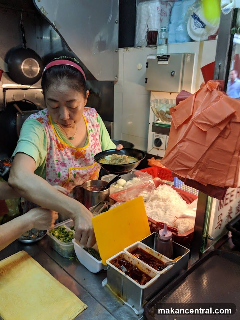 Food stall vendor preparing a dish