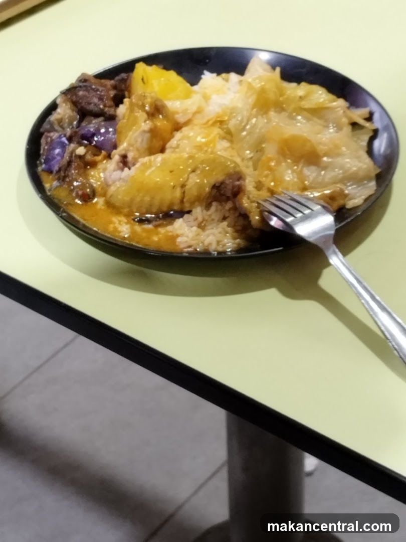 Plate of food with rice, chicken, and vegetables