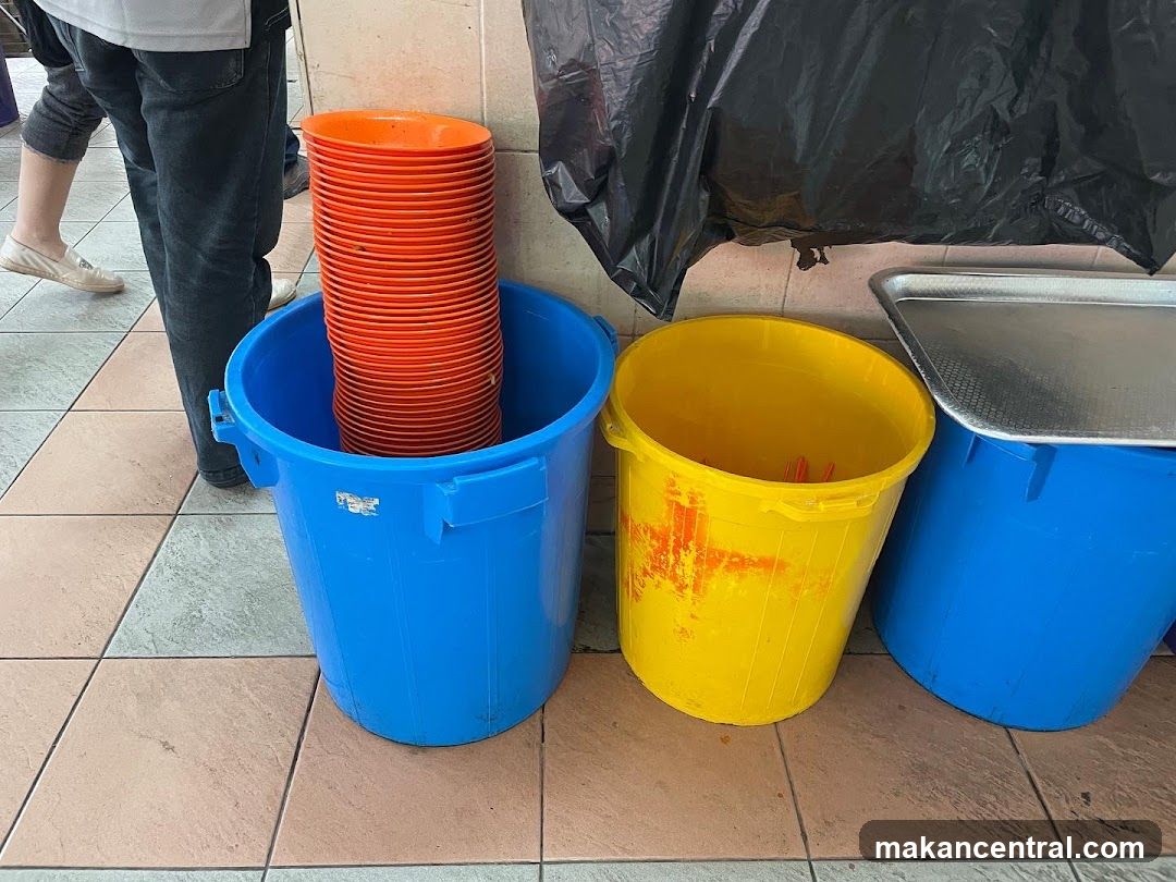 Stack of Orange Plates in Blue Bucket