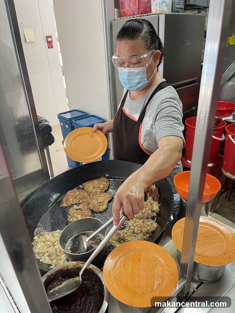 Woman cooking food on a large pan