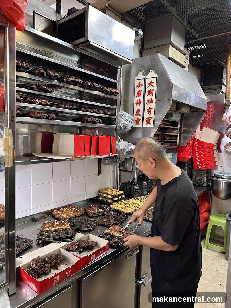Baker arranging muffins