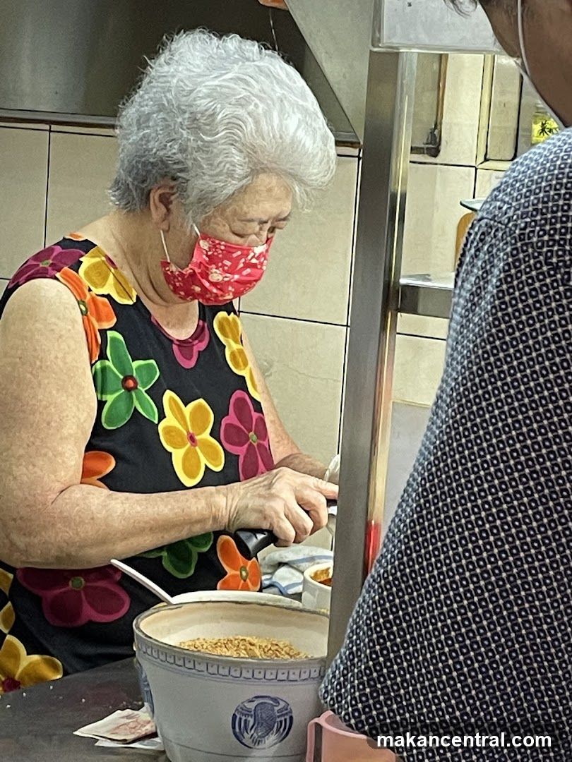 Elderly woman preparing food