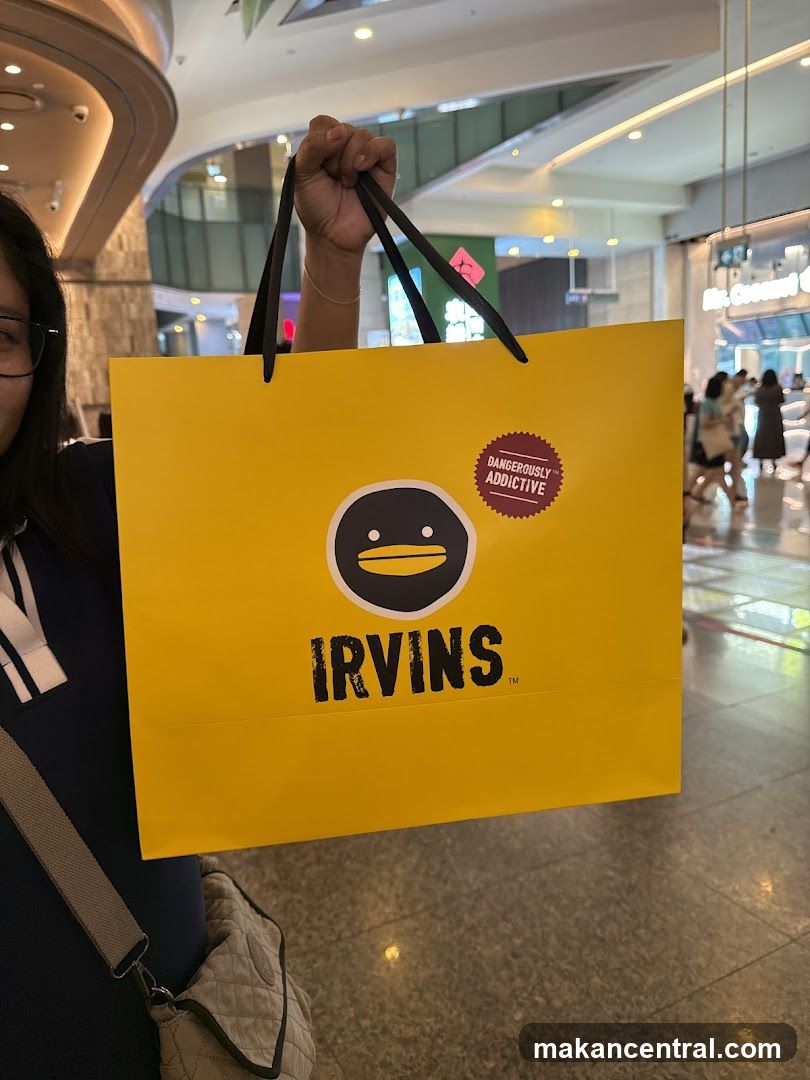 Person holding an Irvins shopping bag
