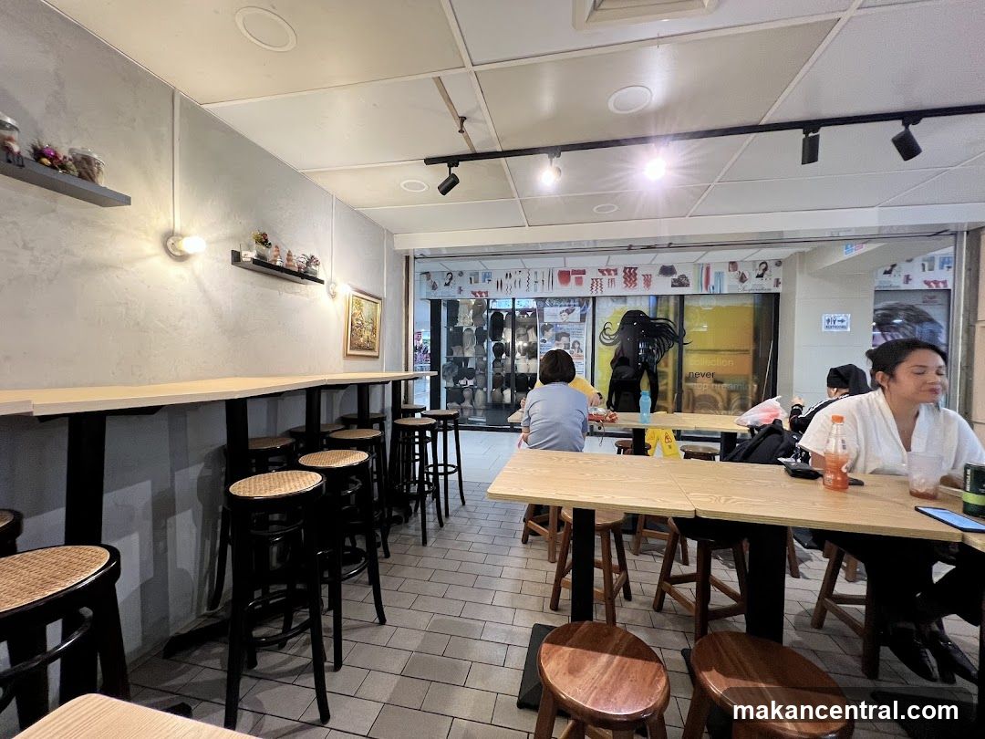 Interior of a cafe with bar seating and tables