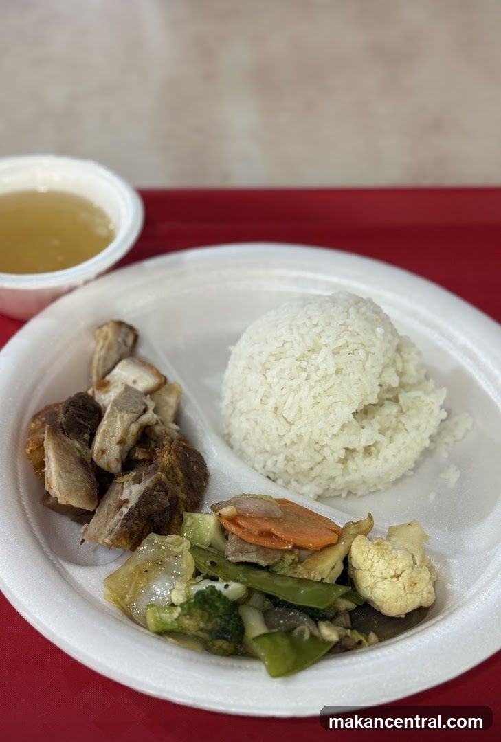 Plate of food with rice, meat, and vegetables