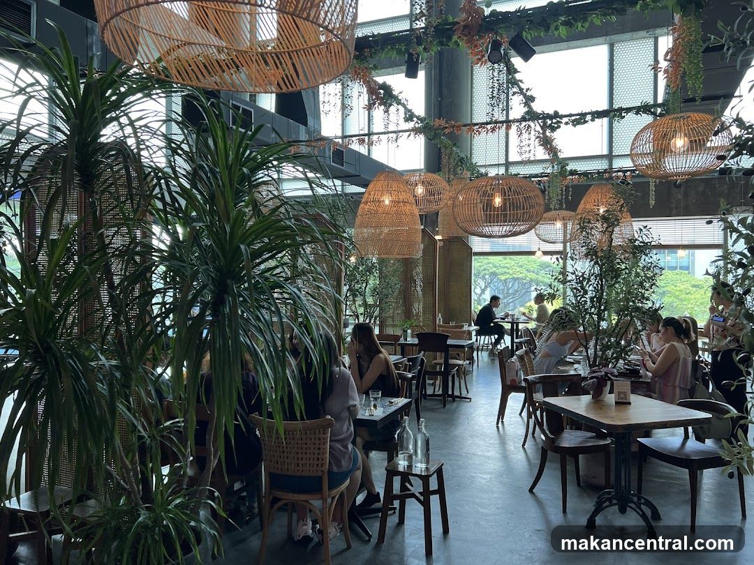 Restaurant Interior with Lush Greenery and Woven Pendant Lights