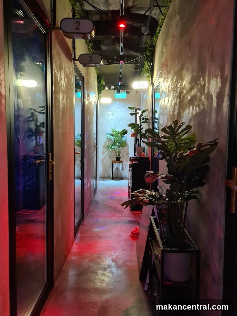 Hallway with numbered doors and plants