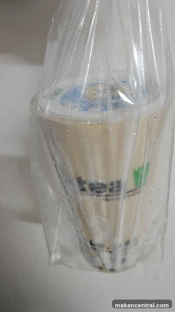 Two bubble tea drinks in a plastic bag
