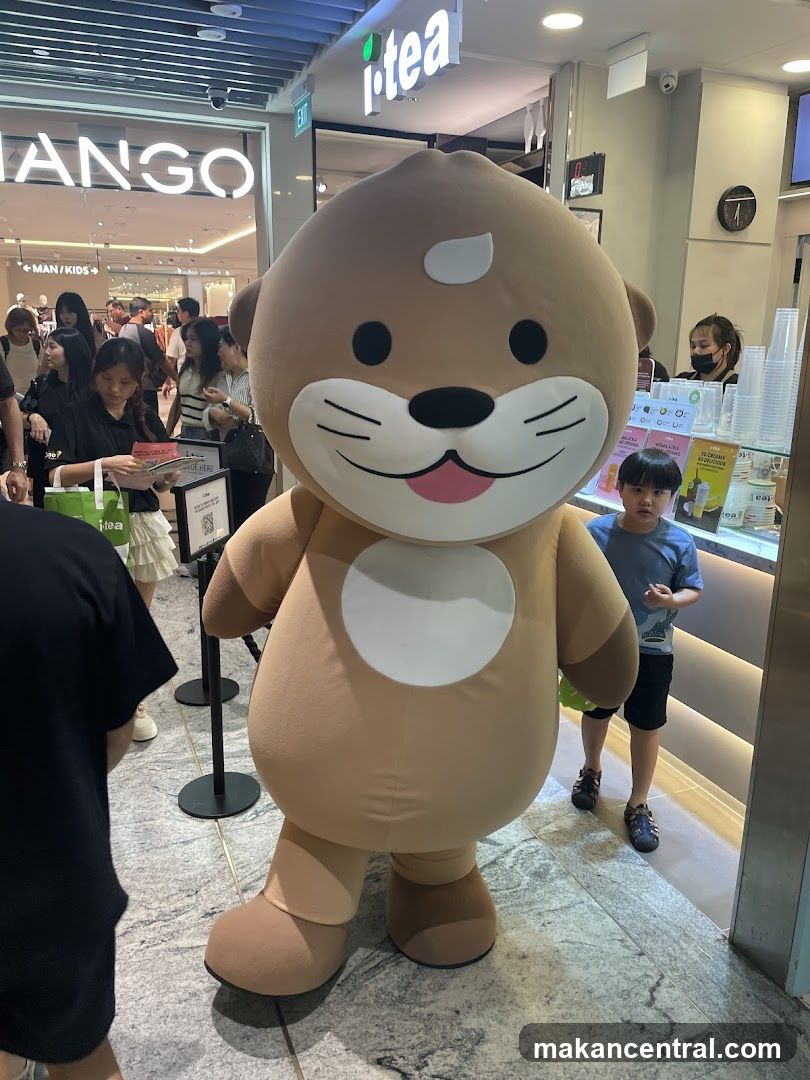 Mascot in front of i-tea store