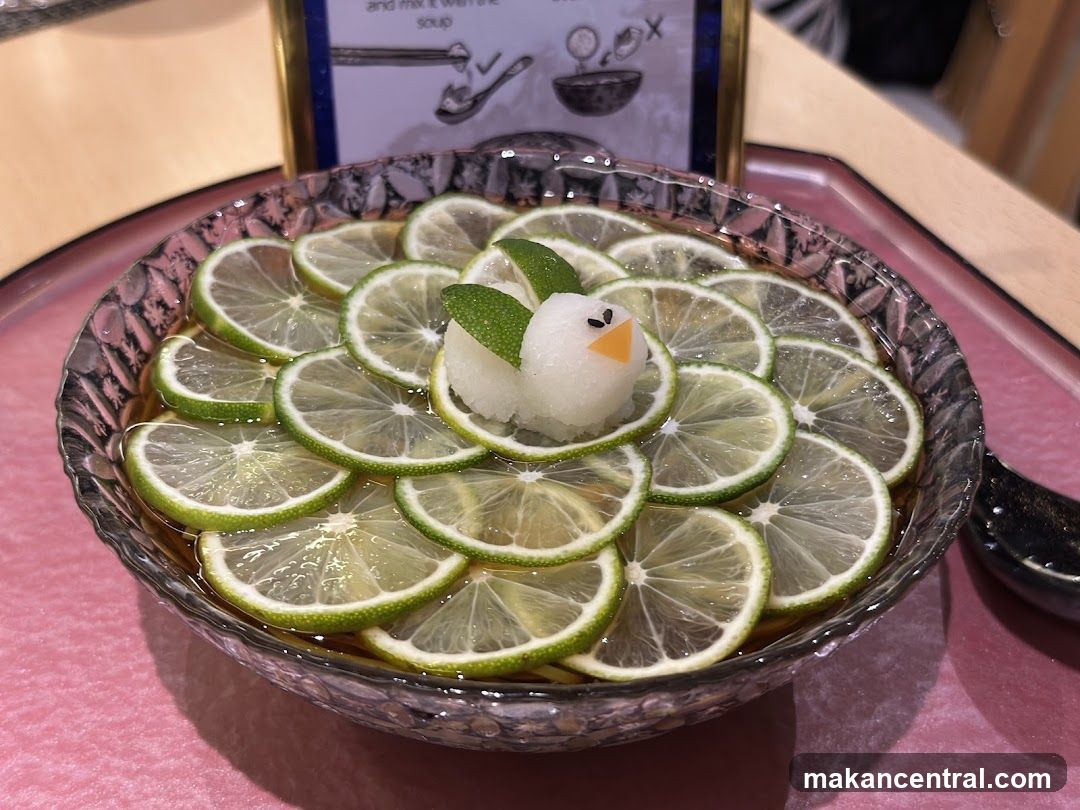 Noodle dish with lime slices and a bird-shaped garnish