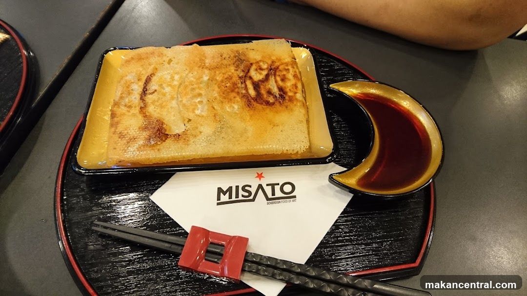 Pan-fried dumplings with dipping sauce
