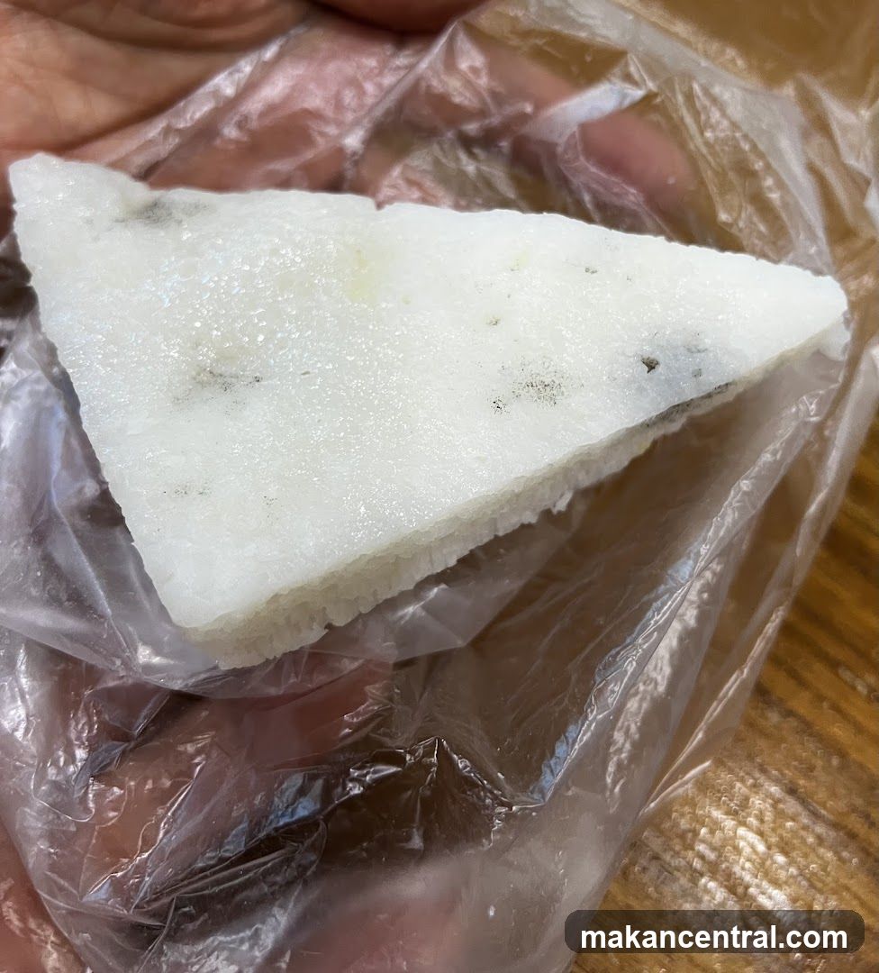 Slice of white food in plastic wrap