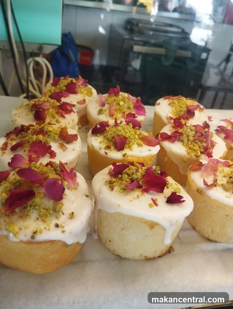 Mini Cakes with White Icing and Rose Petals