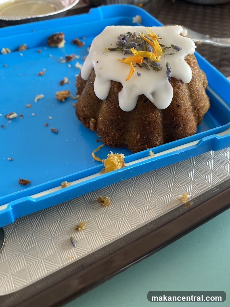 Bundt cake with white icing and edible flowers