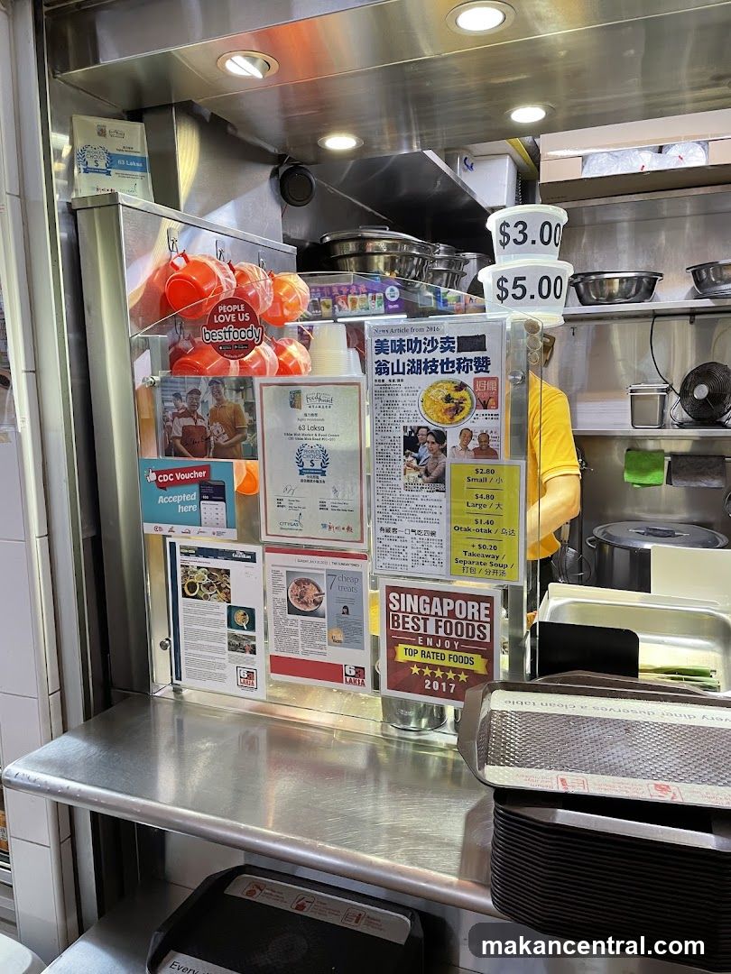 Food stall display with awards and menu items