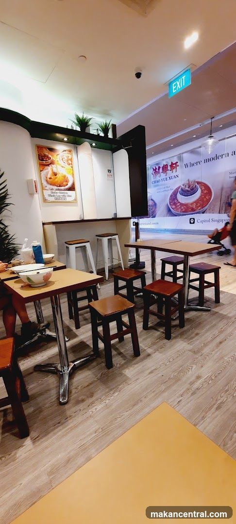 Restaurant Interior with Seating and Advertisement