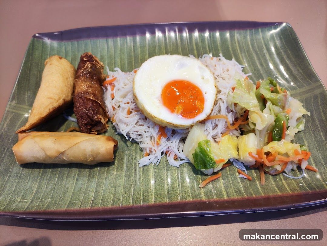 Fried Egg with Rice and Spring Rolls