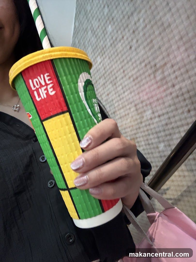 Person holding a colorful cup