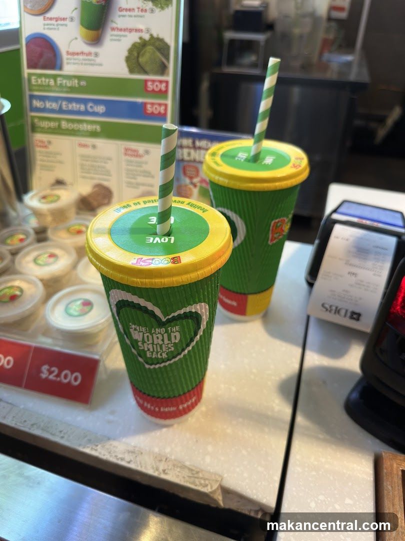 Two drinks with straws on a counter