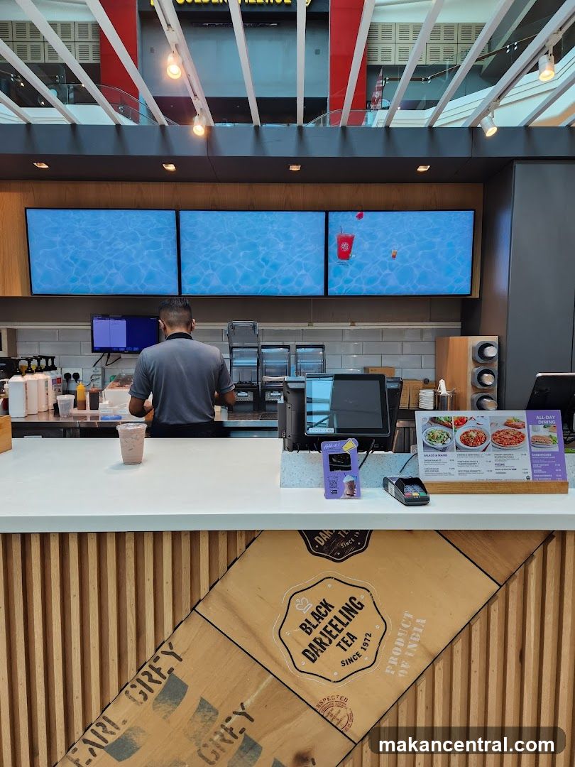 Counter with digital menu screens and staff
