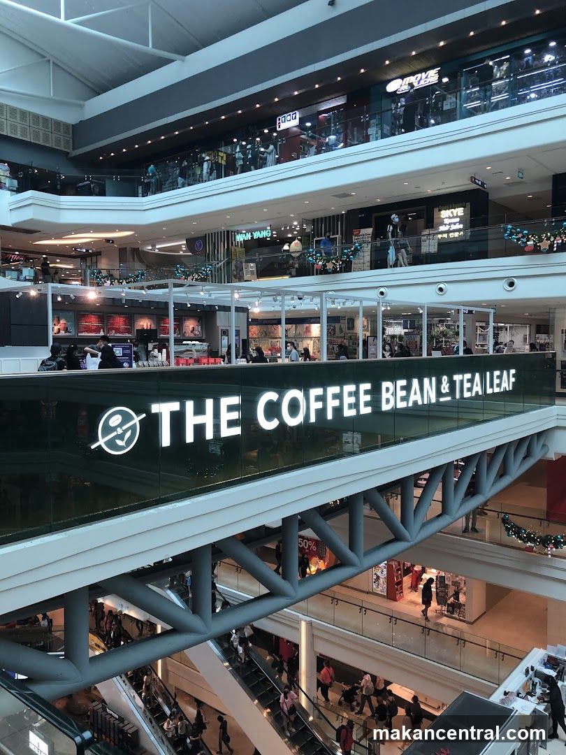 Interior of a multi-level shopping mall with The Coffee Bean & Tea Leaf signage