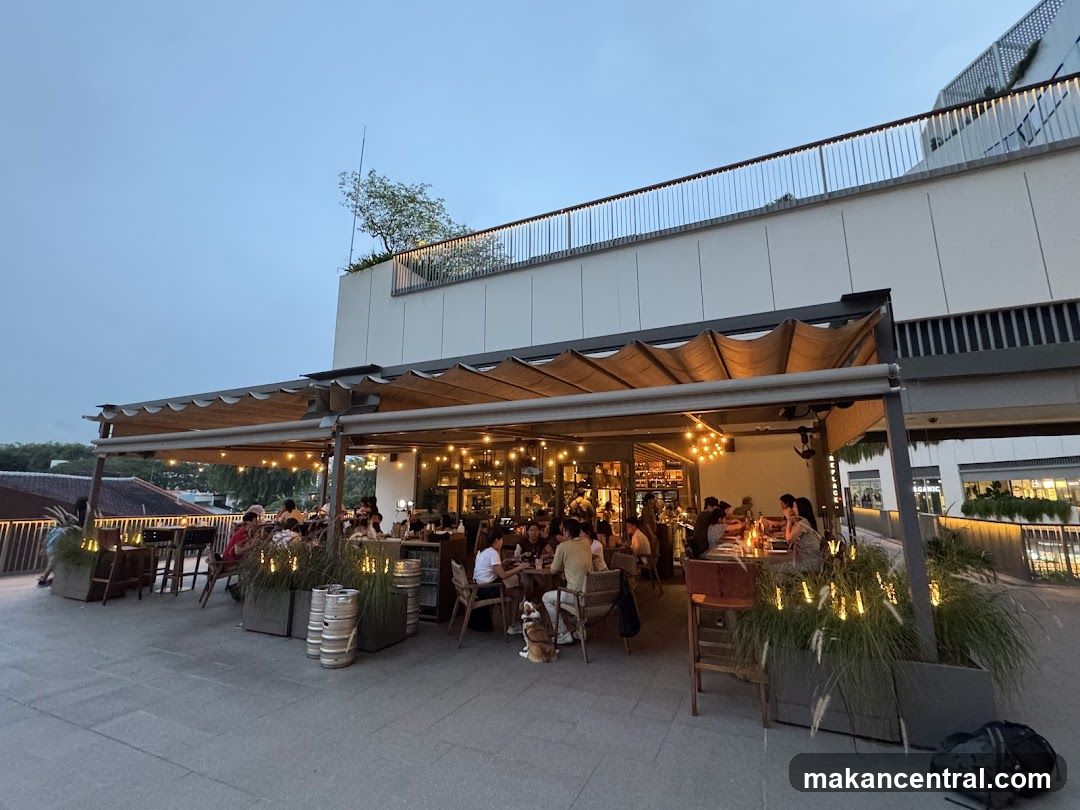 Outdoor dining area with people eating and drinking