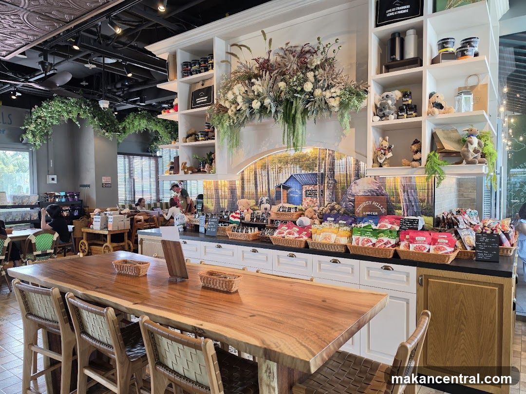 Interior of a grocery store with a large wooden table in the foreground.
