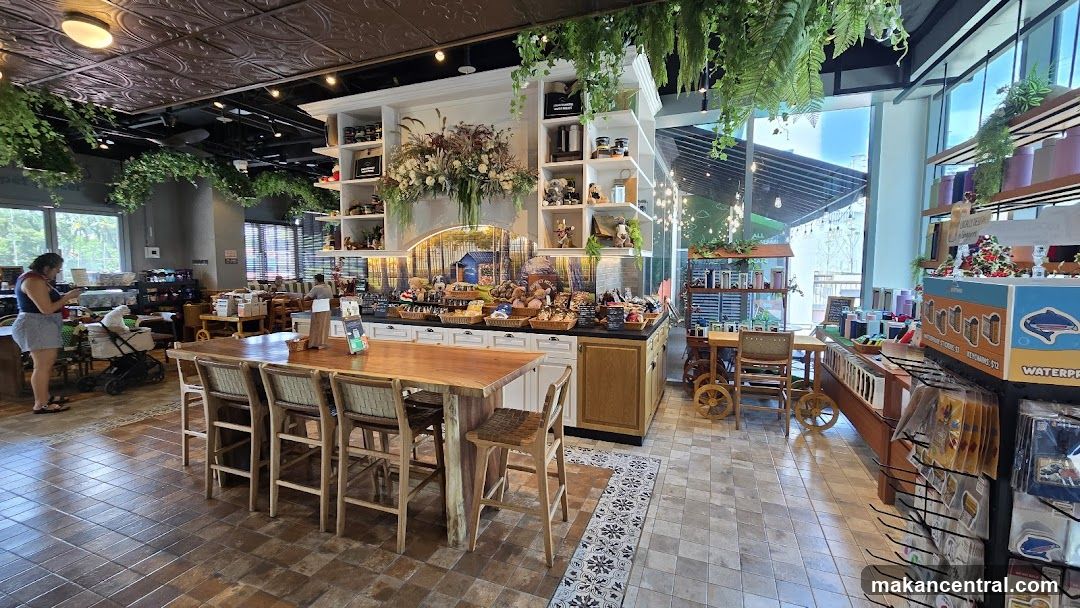 Interior of a shop with a long wooden table and chairs