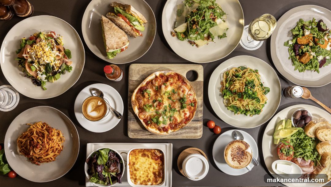 Overhead view of a table laden with various dishes and drinks
