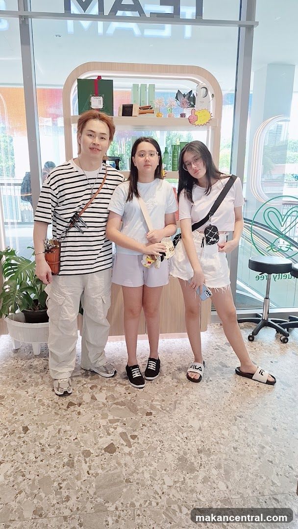 Three people posing in a store