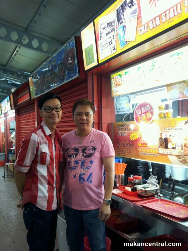 Two Men in Front of a Food Stall