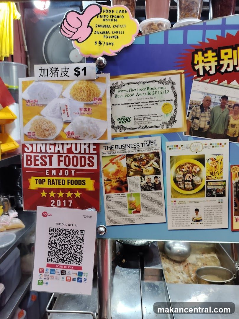 Food stall display with awards and menu items
