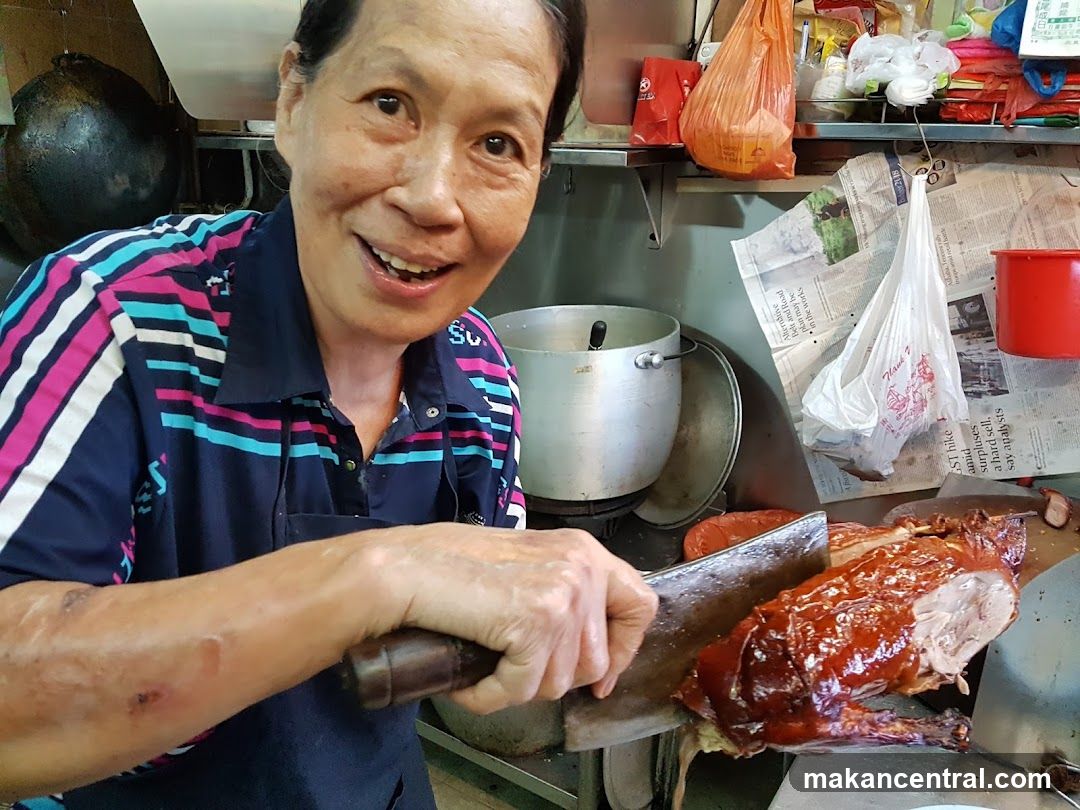 Woman Carving Roasted Duck