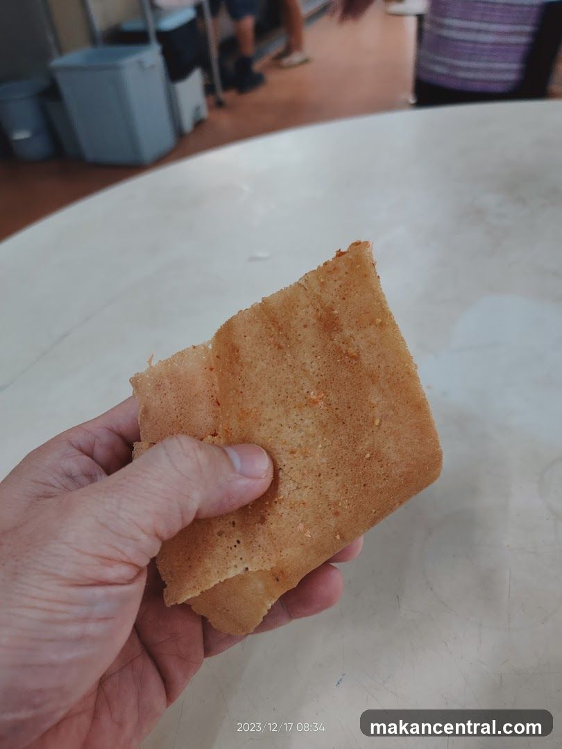 Hand holding a piece of pancake