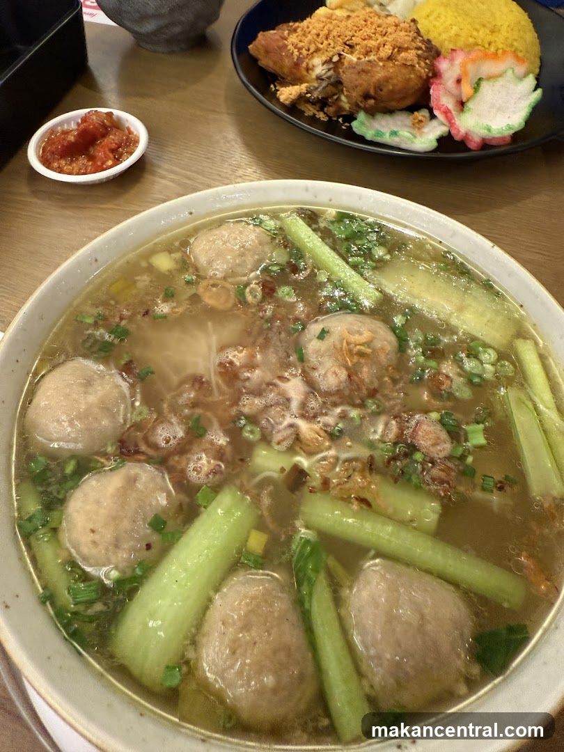Bowl of Soup with Meatballs and Fried Chicken Dish
