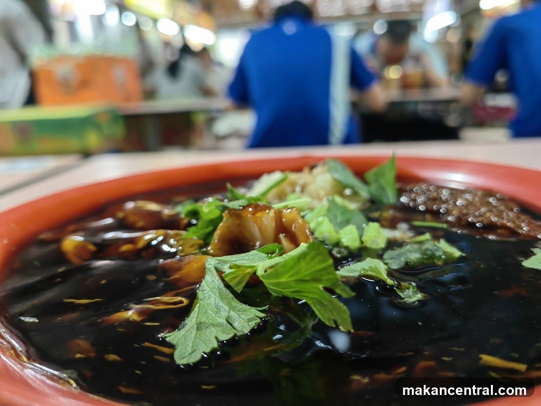 Close-up of a dark sauce dish with garnishes