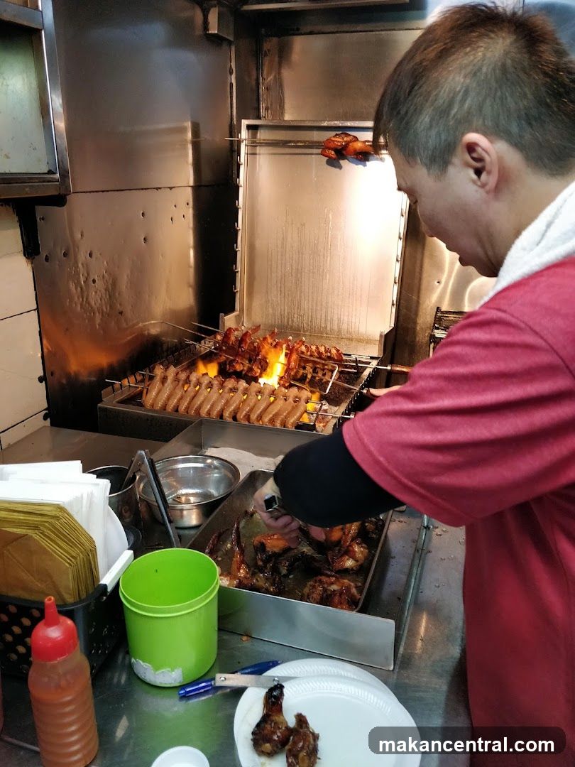Man preparing roasted chicken wings